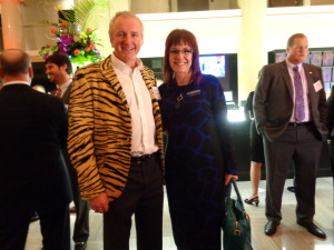 Among those greeting Glenwood Springs car dealer Michael Payne in his “tiger-striped” jacket was Charlene Bowlin of Security Service Federal Credit Union. At right is Casey Tynan. (Jan Wells photo)