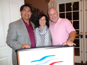 David Muramoto, left, new president of the Rocky Mountain Automotive Press, is with Kelley Enright of FiatChryslerAutomotive in Chicago, and Kurt Hansen, broadcast host of Race Central. (Jan Wells photo)