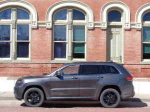 The ultramodern Jeep Grand Cherokee EcoDiesel 4X4 rests beside the 130-year-old former Bank of Oberlin (Kansas) building. (Jan Wells)