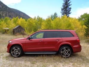 A cardinal red Mercedes-Benz GLS550 adds beauty with the yellowing aspen leaves near the old Kinikinik store in Poudre Canyon. (Bud Wells photo)